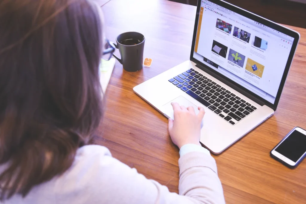 A girl browsing a website on her laptop.